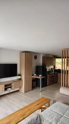 a living room with a couch and a tv and a kitchen at New Countryside Apartaloft 213 in El Retiro