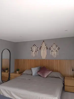 a bedroom with a large bed and some decorations on the wall at New Countryside Apartaloft 213 in El Retiro