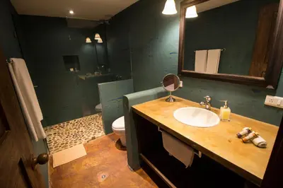 a bathroom with a sink and a toilet and a mirror at Casa Del Reloj in Medellín