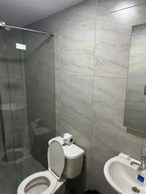 a bathroom with a toilet and a sink at Hotel Ciento Once Boutique Laureles in Medellín