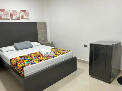 a bedroom with a bed with a stuffed animal on it at Hotel Ciento Once Boutique Laureles in Medellín