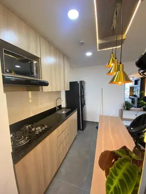 a kitchen with a counter and a stove top oven at Lujoso y acogedor apartamento in Sabaneta