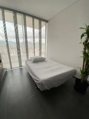 a white room with a bed and a large window at Lujoso y acogedor apartamento in Sabaneta