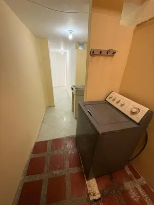 an empty room with a large appliance on the floor at Cómodo Family Laureles-Estadio 4BR cerca la 70 maximo 10 personas in Medellín