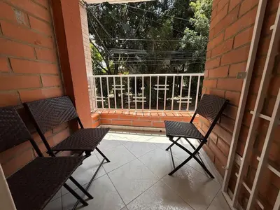 two chairs sitting on a porch with a balcony at Cómodo Family Laureles-Estadio 4BR cerca la 70 maximo 10 personas in Medellín