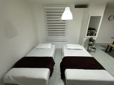 two beds in a small room with at Cómodo Family Laureles-Estadio 4BR cerca la 70 maximo 10 personas in Medellín