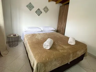 a bedroom with a bed with two towels on it at Casa amplia y acogedora en el corazón de Laureles in Medellín