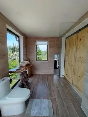 a bathroom with a toilet and a window at Increíble villa de lujo, vistas espectaculares in Guatapé