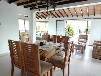 a dining room with a table and chairs at Increíble villa de lujo, vistas espectaculares in Guatapé