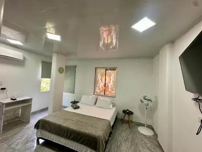 a bedroom with a bed and a sink and a fan at Apartamento días - weeks with kitchen in Santa Fe de Antioquia