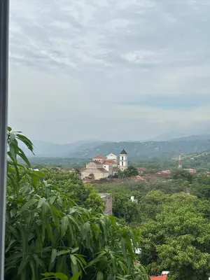 a view of a house in the middle of trees at Apartamento días - weeks with kitchen in Santa Fe de Antioquia