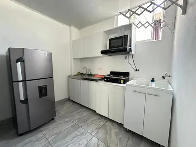 a kitchen with white cabinets and a stainless steel refrigerator at Apartamento días - weeks with kitchen in Santa Fe de Antioquia