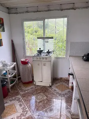 a kitchen with an old stove and a window at Andean Mot Mot Coffee - Puerto Asís Farm in Aranzazu