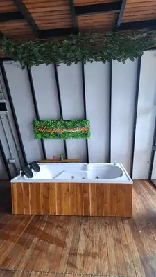 a bath tub in a room with a wooden floor at Glamping Arcoiris in Ciudad Bolívar