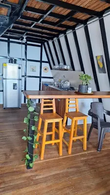 a kitchen with a large wooden table and chairs at Glamping Arcoiris in Ciudad Bolívar