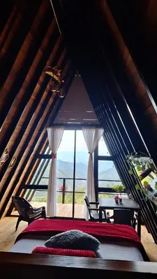 a bedroom with a large window in a attic at Glamping arcoiris r in Ciudad Bolívar