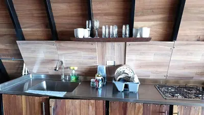 a kitchen with a sink and a stove at Glamping arcoiris r in Ciudad Bolívar