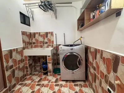 a washer and dryer in a small kitchen with a counter at Apartamento en Belen cerca a Laureles, wifi, Balcon y Patio in Medellín