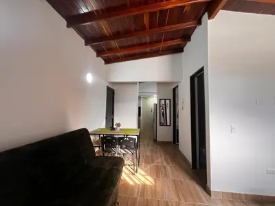 a living room with a couch and a table at Bombona Apartment in Medellín