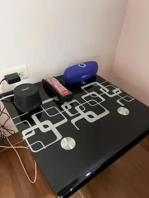 a table with two remote controls on top of it at Bombona Apartment in Medellín