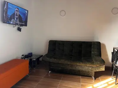 a living room with a couch and a flat screen tv at Bombona Apartment in Medellín