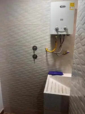 a bathroom with a sink and a machine on the wall at Bombona Apartment in Medellín