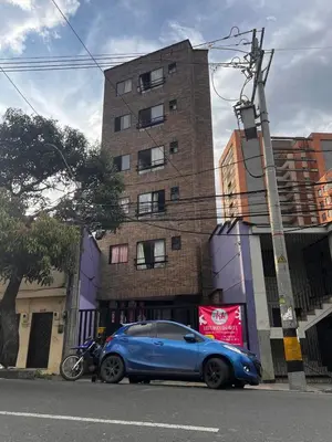 a blue car parked in front of a building at Bombona Apartment in Medellín