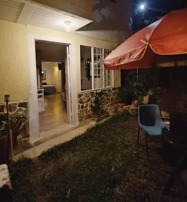 a house with a chair and an umbrella at Moderno y acogedor departamento in Concepción
