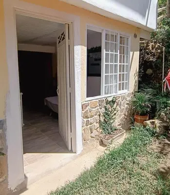 an open door of a house with a porch at Moderno y acogedor departamento in Concepción