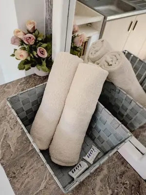 a couple of towels on a counter in a bathroom at Moderno y acogedor departamento in Concepción