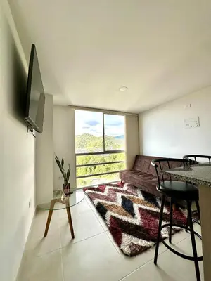 a bedroom with a bed and a large window at Lindo Apto central Urban Mzles in Manizales