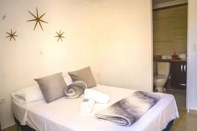 a bedroom with a bed with a blanket and stars on the wall at Comodo apartamento 2-2 - Parqueo cubierto para 1 carro - En el corazón de Guatape in Guatapé