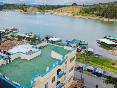 an aerial view of a house in the water at Comodo apartamento 2-2 - Parqueo cubierto para 1 carro - En el corazón de Guatape in Guatapé