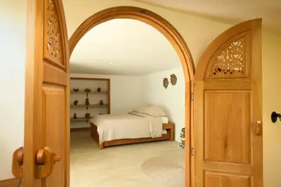 a bedroom with a bed and an open door at Villa Talataa in Tarso