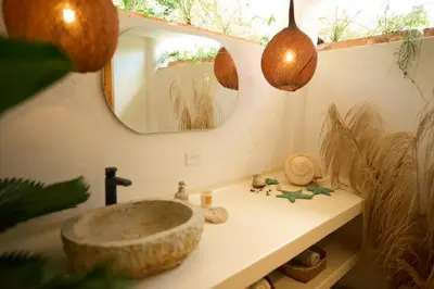 a bathroom with a sink and a mirror at Villa Talataa in Tarso