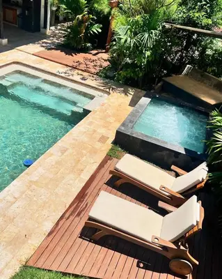 two lounge chairs on a deck next to a swimming pool at Villa Talataa in Tarso