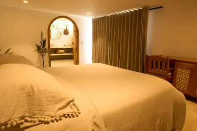 a bedroom with a large white bed in a room at Villa Talataa in Tarso