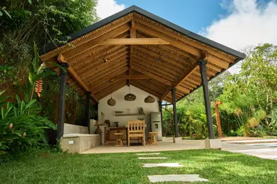 a pavilion with a table and chairs in a yard at Villa Talataa in Tarso