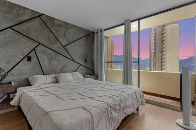 a bedroom with a large bed and a large window at 15minPOBLADO-LUXURY-Sabaneta in Sabaneta