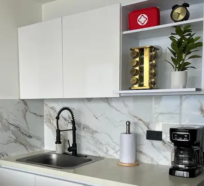a kitchen with a sink and a counter top with a coffee maker at 15minPOBLADO-LUXURY-Sabaneta in Sabaneta