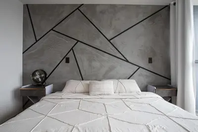 a bedroom with a white bed with a geometric headboard at 15minPOBLADO-LUXURY-Sabaneta in Sabaneta