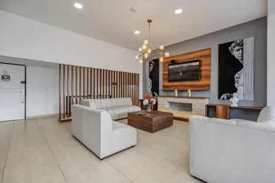 a living room with white furniture and a fireplace at Luxury Penthouse Con Aire acondicionado in Envigado