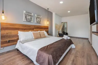 a bedroom with a large bed and a flat screen tv at Luxury Penthouse Con Aire acondicionado in Envigado