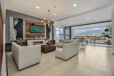 a living room with a couch and a fireplace at Luxury Penthouse Con Aire acondicionado in Envigado