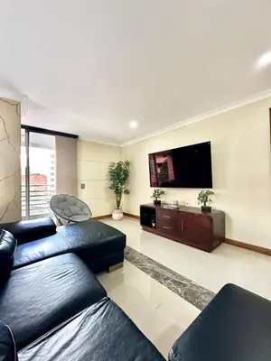 a living room with a couch and a flat screen tv at Beautiful Laureles apartment in Medellín