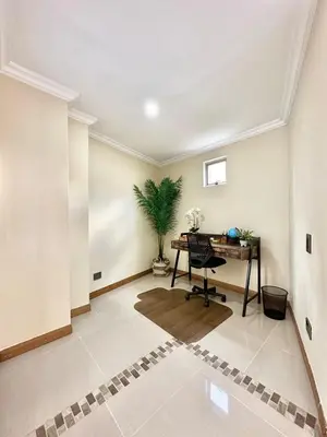 an empty room with a desk and a plant at Beautiful Laureles apartment in Medellín