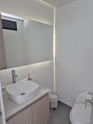 a white bathroom with a sink and a toilet at Laureles 11th Floor, Jacuzzi and AC in Medellín