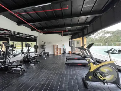 a gym with several treadmills and cardio machines at Suite Rioverde Hotel Rionegro in Rionegro