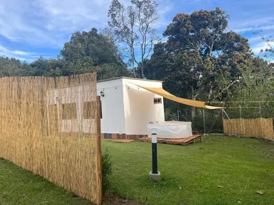 a fence with a tent next to a building at Ohana in Medellín