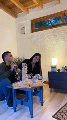 a man and a woman sitting at a table with a chessboard at Ohana in Medellín